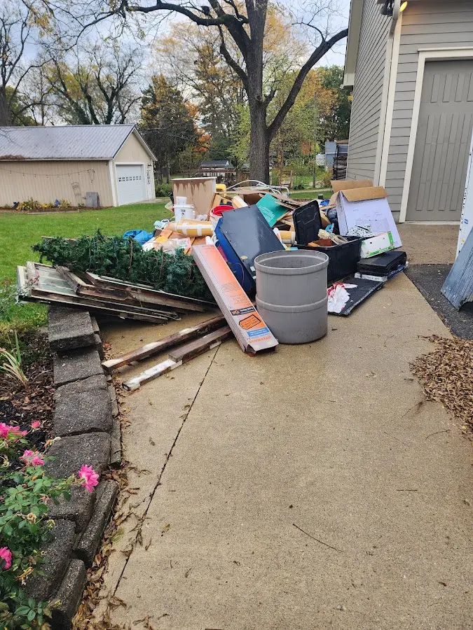 Dumpster being loaded with debris for 10 Yard Dumpster Rental in Lone Tree